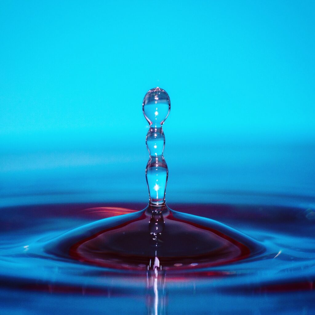 Macro shot of a water droplet on a vibrant blue background